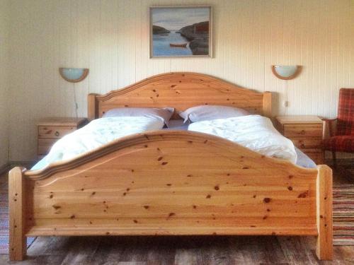 a wooden bed with two pillows in a bedroom at Six-Bedroom Holiday home in Bud in Bud