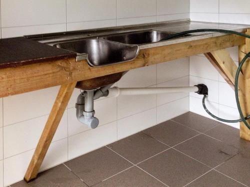 a kitchen sink with a hose under it at Six-Bedroom Holiday home in Bud in Bud
