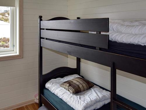 - un lit superposé noir avec un oreiller au-dessus dans l'établissement Holiday home Aseral II, à Tjaldal