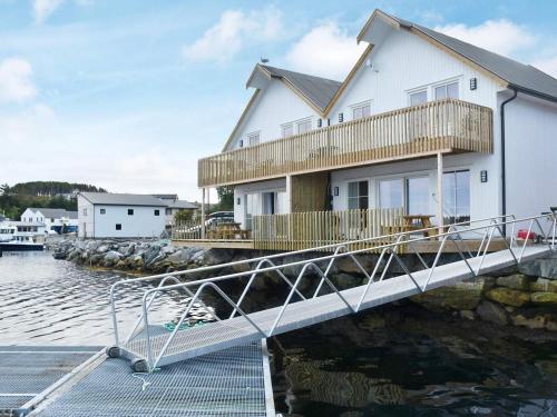a house on a dock next to the water at 6 person holiday home in Kverva in Dyrvik