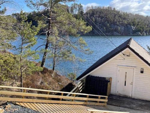 a small building with a view of a lake at 6 person holiday home in Rubbestadneset in Rubbestadneset