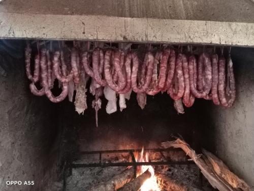 a bunch of sausages hanging over a fire at Hoa Lan Hotel in Bak Kan