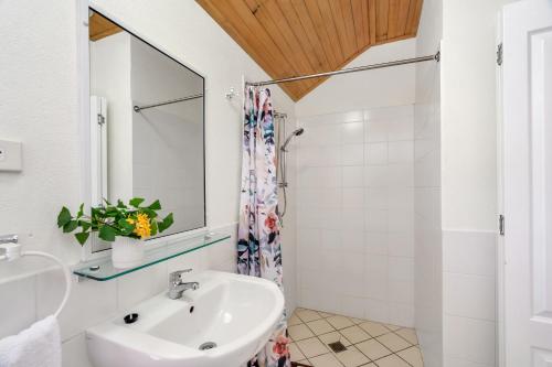 a bathroom with a sink and a mirror at Mission Beach Shores in Mission Beach