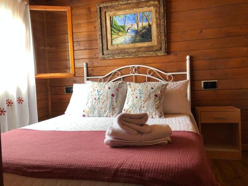 Una cama con un montón de toallas. en Cabañas De Madera Y Bungalows - Gilmañas 3 en La Iruela