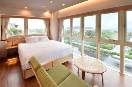 a bedroom with a bed and a large window at BREATH HOTEL in Kamakura