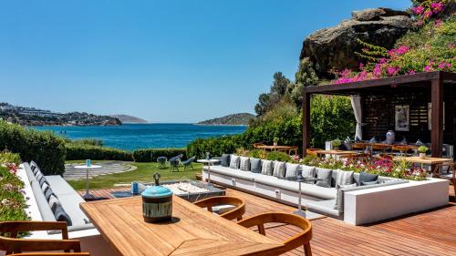 an outdoor patio with a view of the ocean at Sirene Luxury Hotel Bodrum in Yalıkavak