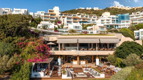 a view of a building with tables and chairs at Sirene Luxury Hotel Bodrum in Yalıkavak