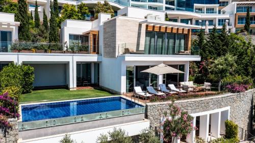 an aerial view of a house with a swimming pool at Sirene Luxury Hotel Bodrum in Yalıkavak
