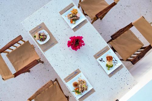 an overhead view of a table with plates of food at Paje White House Boutique Hotel in Paje