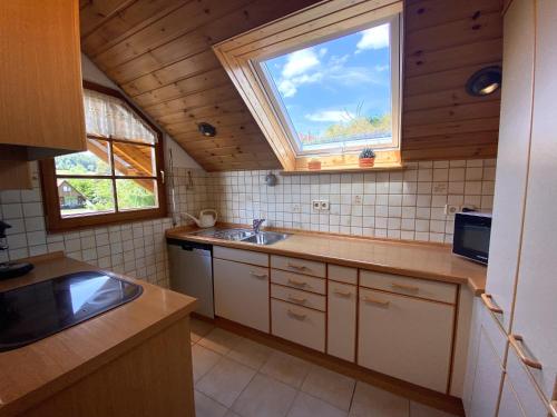 a kitchen with a sink and a window at Ferienwohnung Böllatblick in Balingen