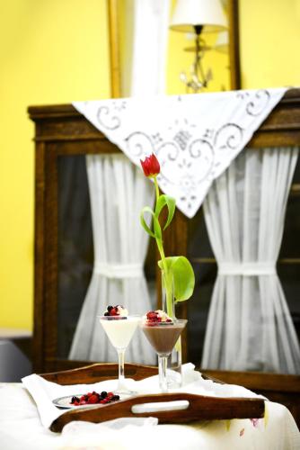 a table with a vase with a flower on it at Ganimede Hotel, Galaxidi in Galaxidhion