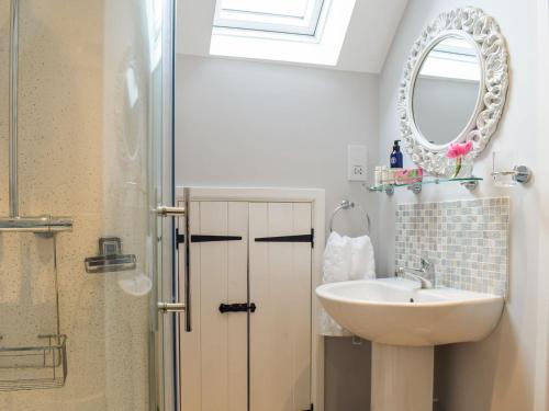 a bathroom with a sink and a mirror at Little Bank Cottage in Lane to Richards Castle