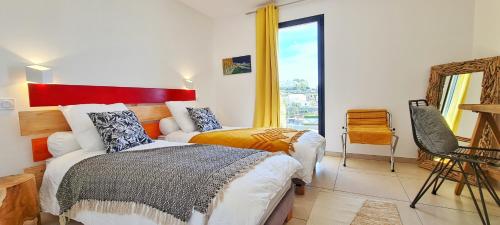 A bed or beds in a room at VILLA ROCCA BRUNA, LE CAP CORSE 5 ETOILES