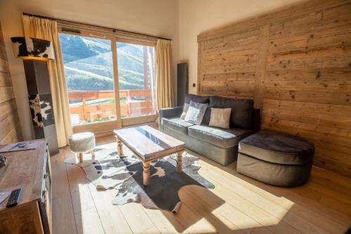 un salon avec un canapé et une table dans l'établissement Sherpa 17 with sauna - Mottaret's snowfront, à Méribel