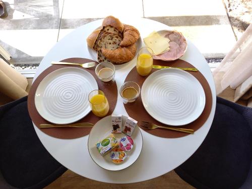 a table with plates of food and glasses of orange juice at B&B Schoonhoven Suites in Elim