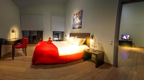 a bedroom with a bed and a desk and a television at Euphoria Club Hotel in Borovets
