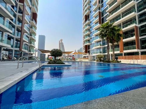 a large swimming pool in the middle of some buildings at HiGuests - Spacious Apt Near Zabeel Park With Panoramic Views in Dubai