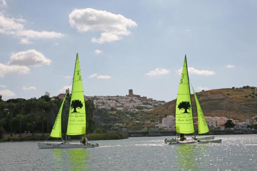 two sailboats in the water on a lake at Arcos Gardens Sol Rent Golf in Arcos de la Frontera