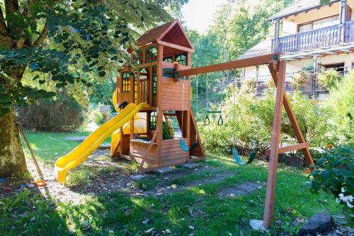 a playground with a slide and a play house at Le Freudeneck in Wangenbourg