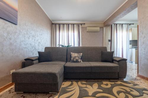 a living room with a couch and a rug at Angy Apartment in Terrasini