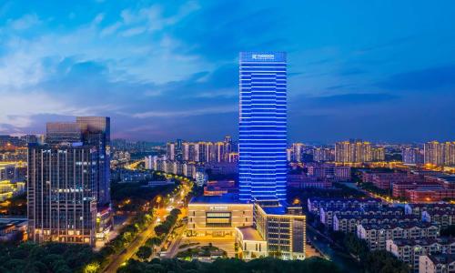 a tall building in a city at night at Radisson Collection, Wuxi in Wuxi