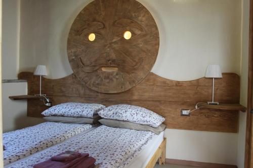 a bedroom with a bed with a large wooden headboard at Chiesa Ignano 1778 in Marzabotto