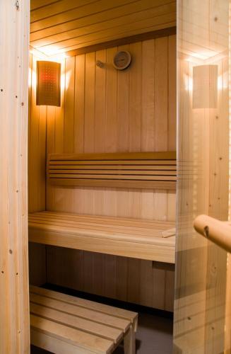 a sauna with a bench in a wooden room at Hotel Emocja SPA in Mielno
