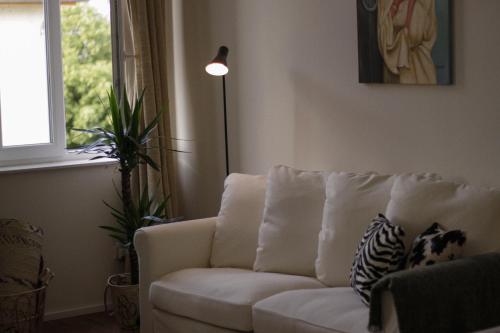 a living room with a white couch and a window at Sleek Studio minutes away from Deutsches Eck in Koblenz