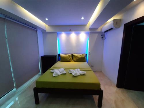 a room with a bed with two towels on it at Cebu City Suites Ramos Tower by P&J in Cebu City