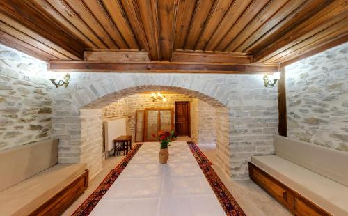a room with a stone wall and a wooden ceiling at Çamlıca Konak Çarsı in Safranbolu