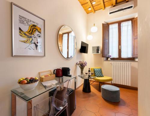 a living room with a table and a mirror at SPIRIT OF FLORENCE Boutique Rooms in Florence