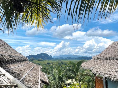 a view of the mountains from the roofs of houses at Baan Phuvara Retreat - Romantic Jacuzzi Mountain View Villas in Ao Nang Beach
