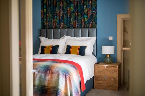 una camera con un grande letto con una parete blu di Lock Keepers Cottage, Loch Ness Cottage Collection a Inverness