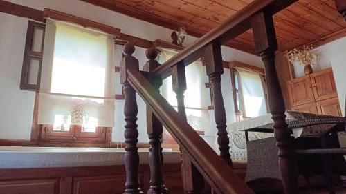 a stairway in a house with windows and a wooden ceiling at Çamlıca Konak Çarsı in Safranbolu