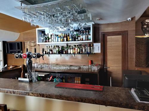 a bar with a lot of glasses on the wall at Goldfinch Retreat Bangalore in Devanahalli-Bangalore