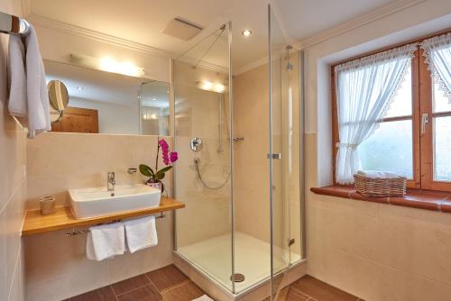a bathroom with a sink and a shower at Gästehaus Bergstüberl in Reit im Winkl