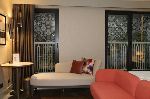 a room with a bed and a couch and a chair at Stayso The House Hotel in Istanbul