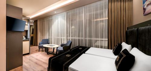 a hotel room with a bed and a table and chairs at Hidden Hills Hotel Istanbul Airport in Istanbul