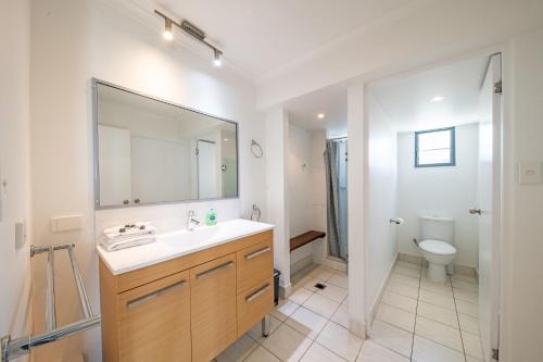 a bathroom with a sink and a toilet at A Point of View in Airlie Beach