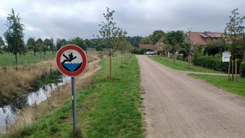a sign on the side of a road next to a river at Apartment Mini-Loft am Schloss in Raesfeld