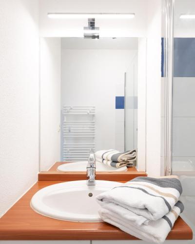 une salle de bain avec un lavabo et un miroir dans l'établissement L'Airbusien - Terrasse et parking - Airbus à coté, à Colomiers