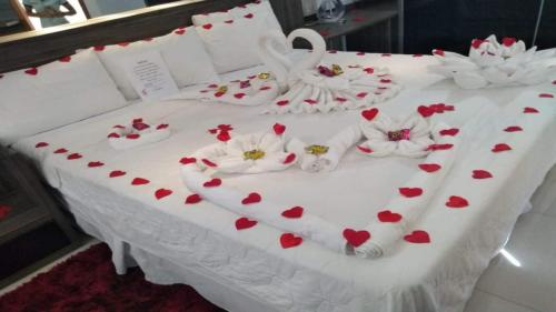 a white table with red hearts and flowers on it at Hotel Shelton Palace in Multan