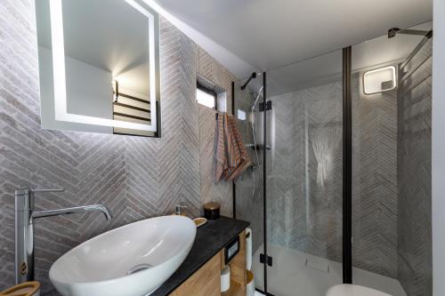 a bathroom with a white sink and a shower at Houseboat Nomadream in Gdańsk