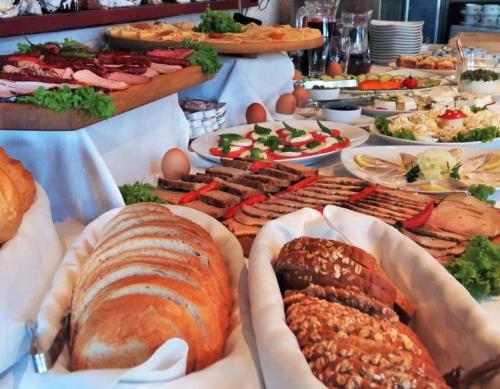 a table topped with lots of different types of food at Weranda Rooms in Tychy