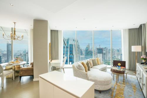 a living room with a couch and a table at Magnolias Ratchadamri Boulevard Serviced Residences in Bangkok