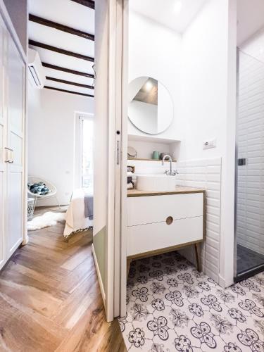 a bathroom with a sink and a mirror at Emma's home Monza in Monza