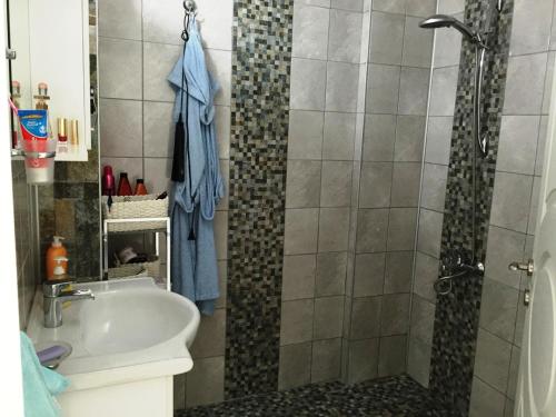 a bathroom with a shower and a sink at Belka Golf Residence Exclusive Apt Poolside in Belek