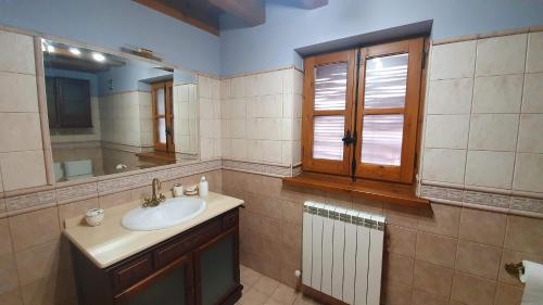 a bathroom with a sink and a mirror at Casa Fraile aisa in Aísa