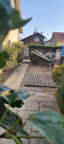 a stone walkway with a gate in a yard at Maison classée 50m océan de 2 à 12 personnes in Mimizan