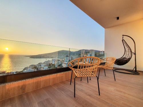 a balcony with two chairs and a table with a view at Meraviglia Boutique Hotel in Sarandë